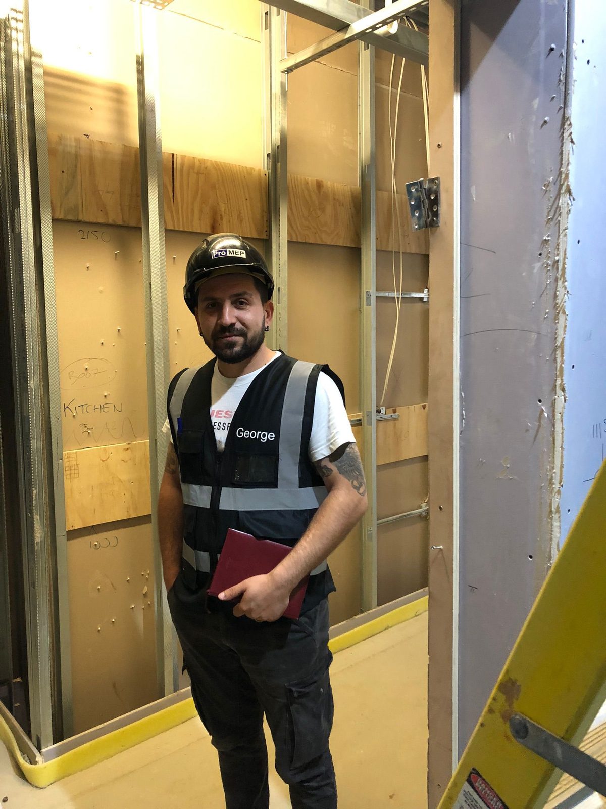 George Ilie - Professional plumber in Bedford with hi-vis safety vest and hard hat