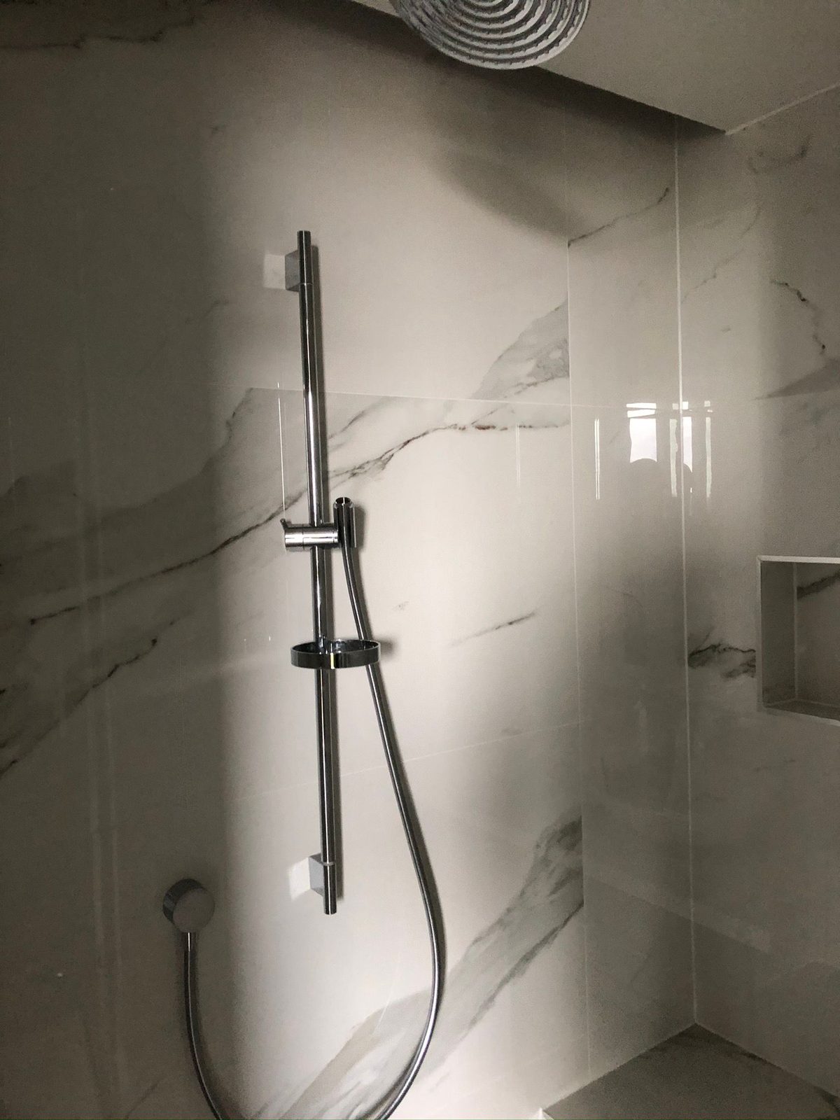 Marble shower installation with chrome fittings in Bedford